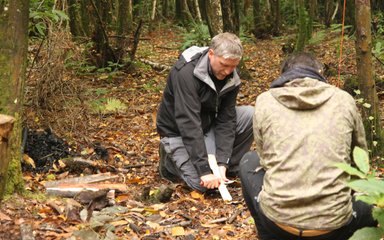 Person whittling wood 