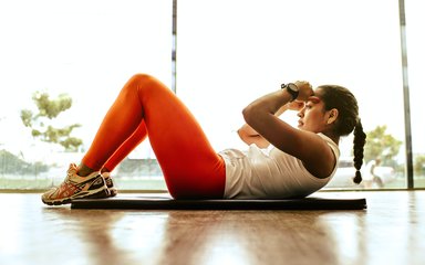 Woman doing sit ups at home