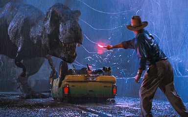 Dr Alan Grant, played by Sam Neill, waves a flare to distract an approach tyrannosaurus rex. 