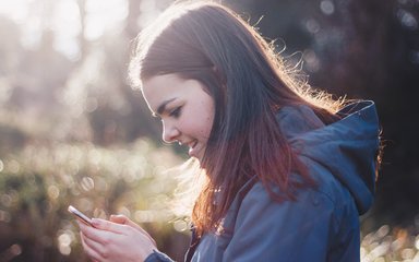 Young woman uses phone