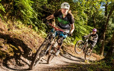 Rider on Mountain Bike through trails in the woods 