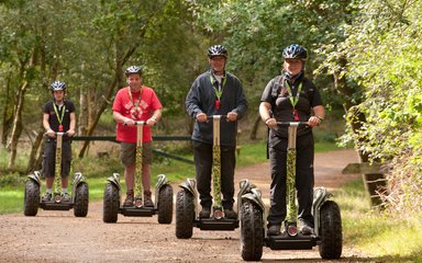 Segway users on a forest trail