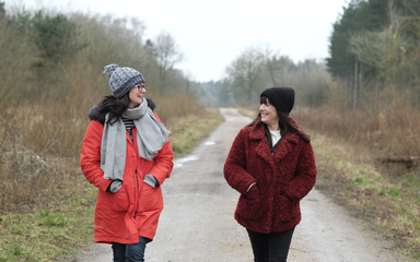 Two friends walking on a path