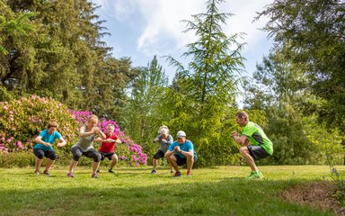 Group of people exercising in the forest