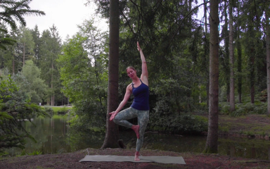 Woman teaching yoga in the forest