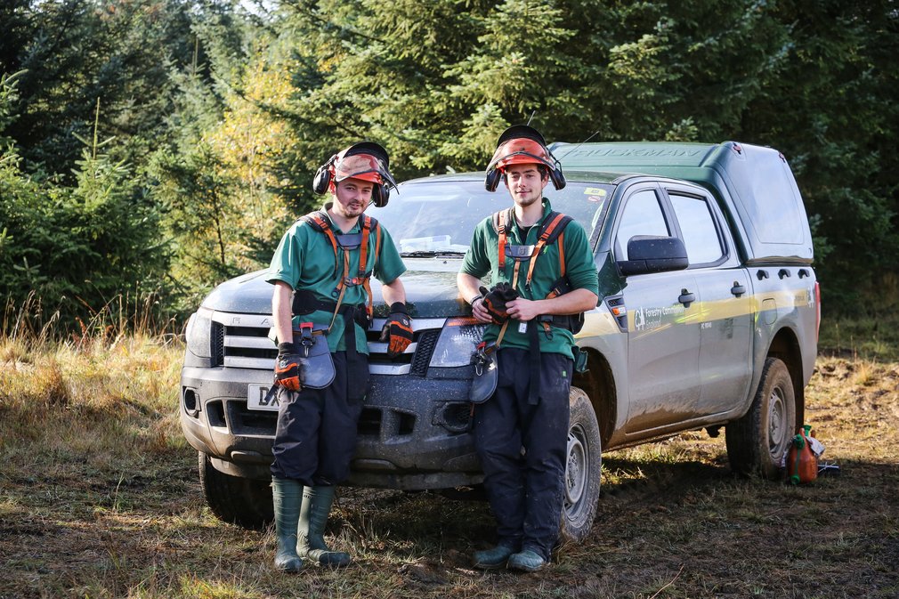 Foresters beside vehicle
