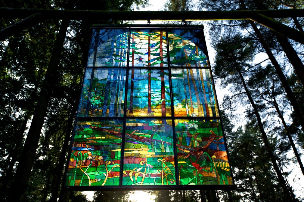 Stained glass pannel hanging in the canopy at beechenhurst sculpture trail