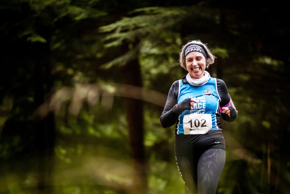 Female trail runner in forest