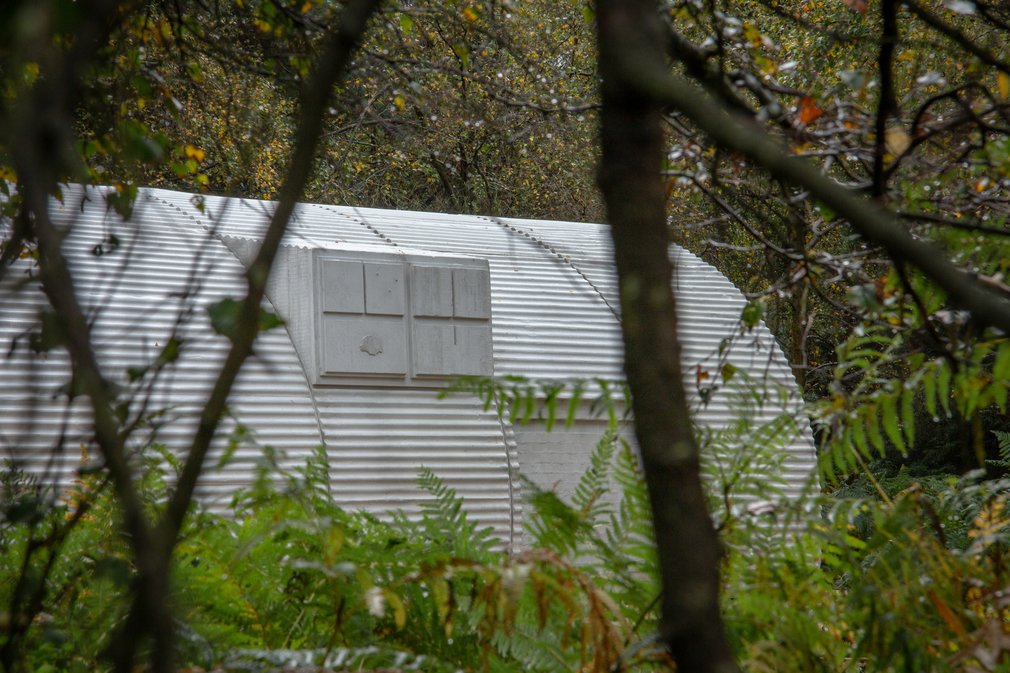 Nissen Hut sculpture through the trees