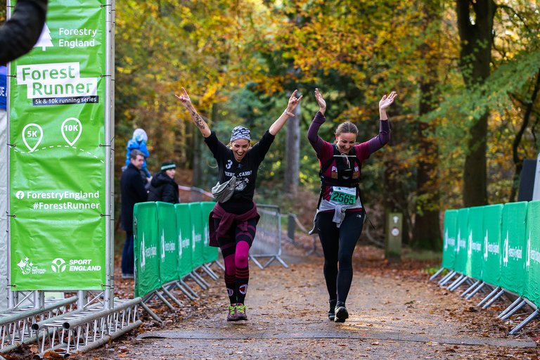 2 happy women ending a running race