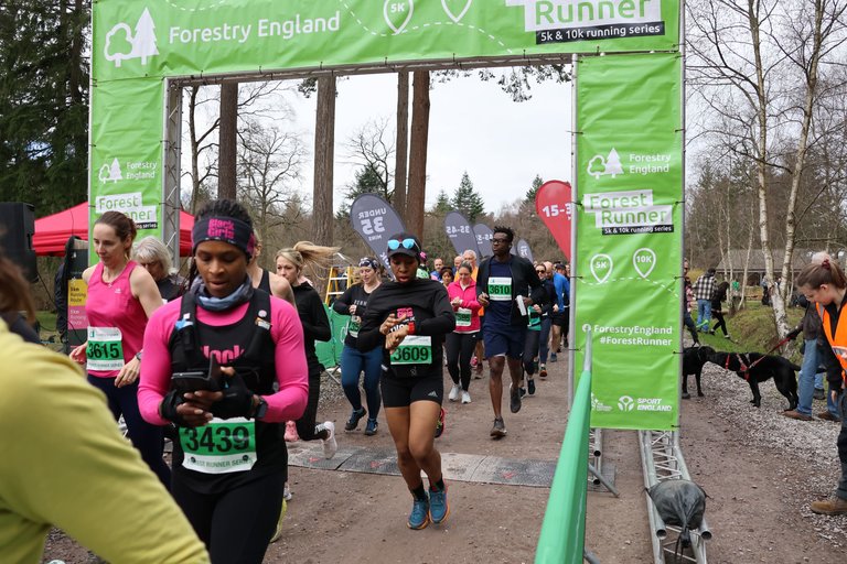 Runners crossing the line at Forestry England event
