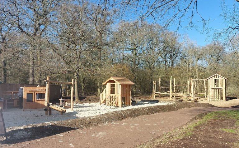 Play area at Salcey Forest featuring wooden play structures and sand