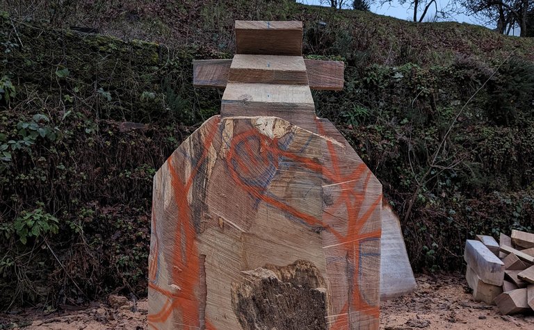 A timber block with coloured lines painted on, and the head of the Gruffalo beginning to take shape.