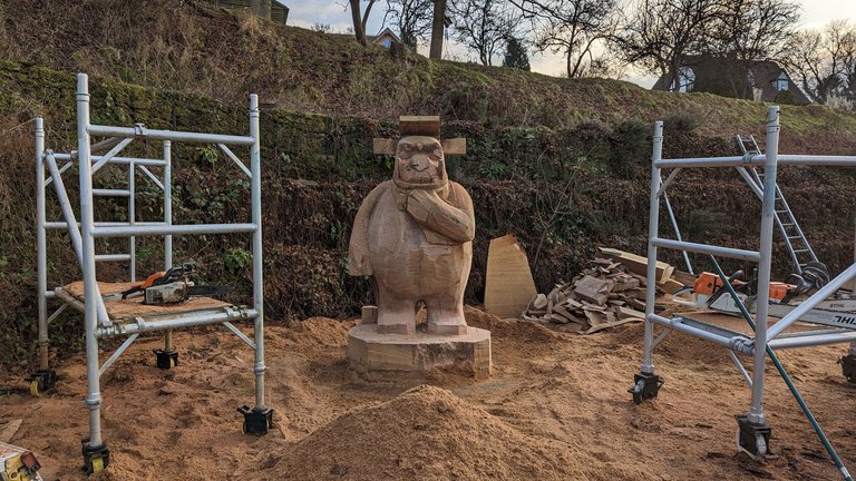 A large wooden carving of the Gruffalo stood between two scaffold platforms