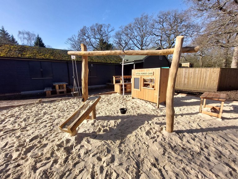 Wooden play equipment in sand at Salcey Forest