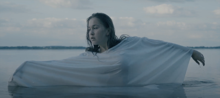 girl in water with a sheet draped over her