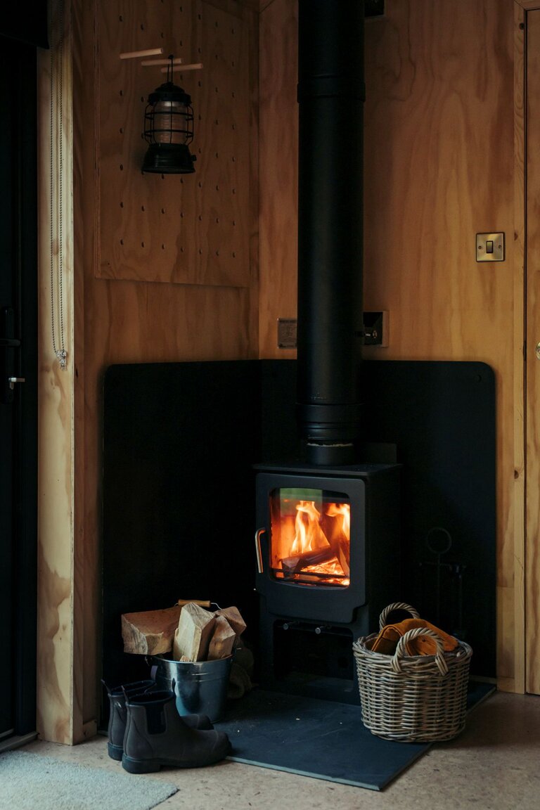 A wood burner in an off- grid cabin