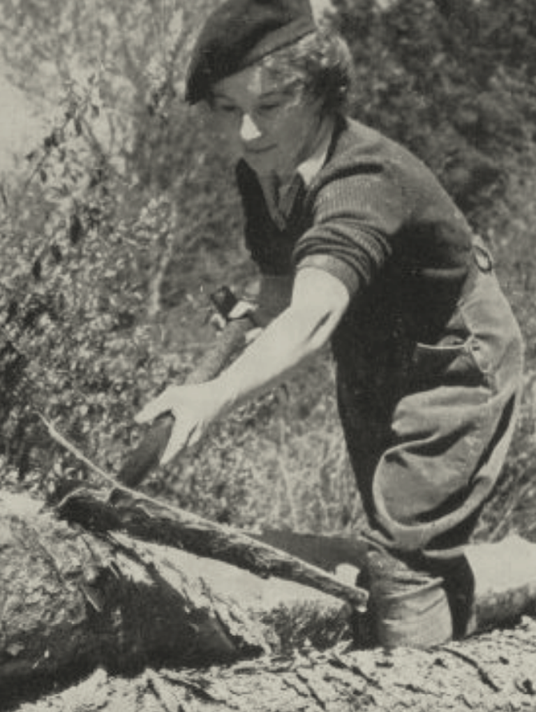 black and white photo of female forestry worker with a pick axe
