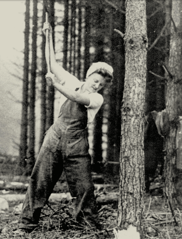 black and white photo of female forestry worker with an axe